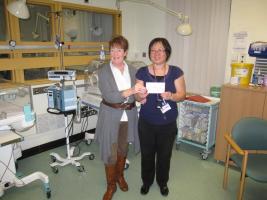Sister Ooi (right) receives a donation of £1,450 from Jane Hurlock.